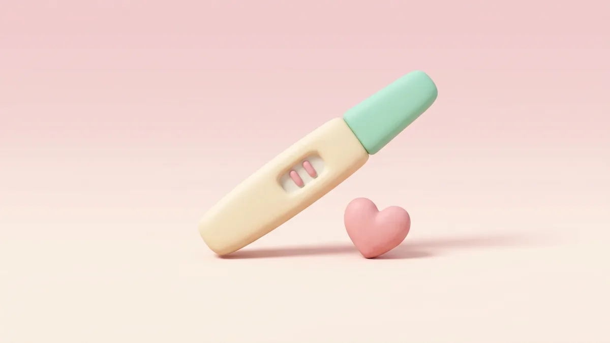 A 3D clay pregnancy test with a pink heart on a soft pink background